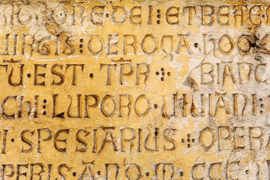 ancient latin script on a house wall in Florence