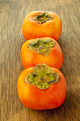 persimmons on a wooden table
