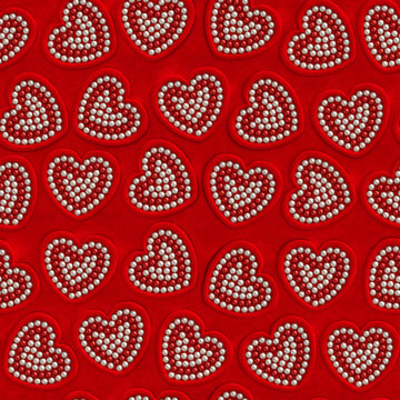 Heart pearl Valentine day seamless background. Red velvet frames in the form of hearts with red and beige pearls on red velure surface as vintage, elegance, romantic, magnificent, jewelry decoration