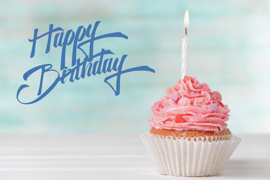 Birthday cupcake on light blue background