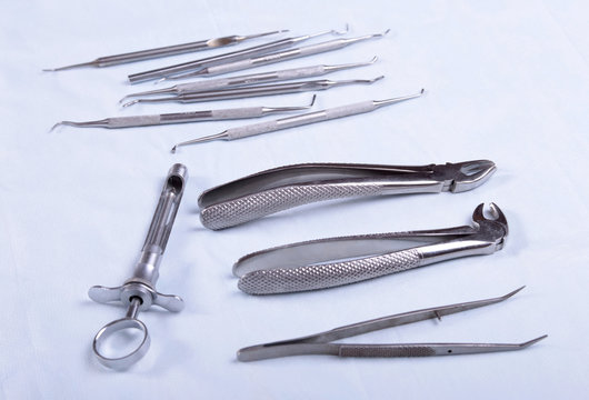 Medical instruments for dentists on blue table