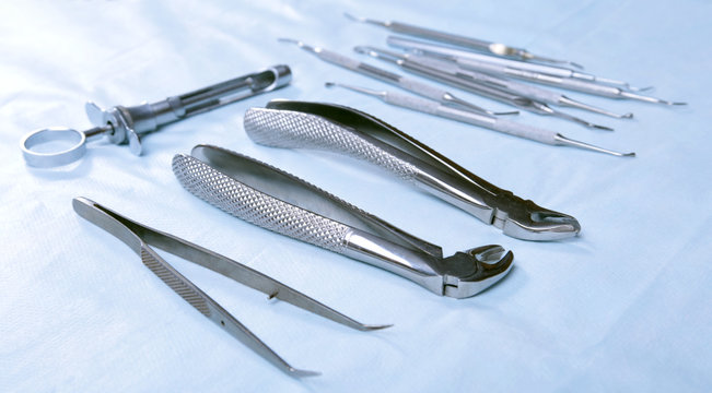 Medical instruments for dentists on blue table