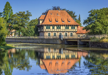 Fototapeta na wymiar Watermill building with reflection in the water in Steinfurt