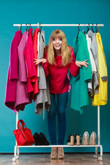 Woman choosing clothes to wear in mall or wardrobe