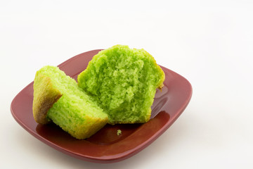 Green pistachio nut muffin on red plate