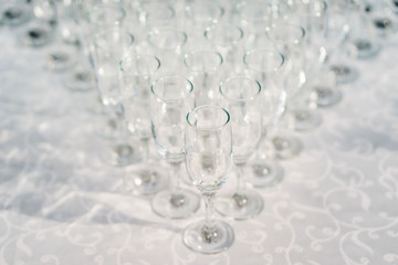 glasses of white wine in a row on the table in pyramid