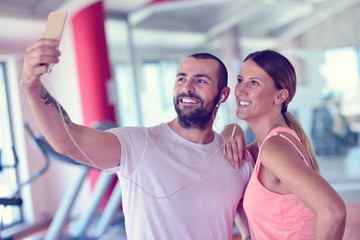 Young couple taking a sefie in a gym