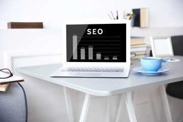 SEO technology concept. Modern workplace interior.