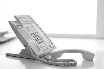 Modern office IP telephone set on light background