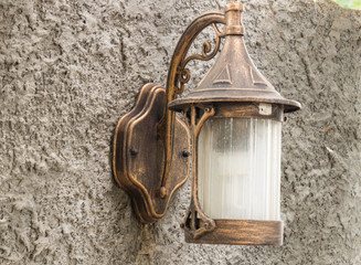 Nice lamp style, In the backyard. Mounted on a wall made of cement.

