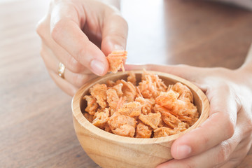 Fried shrimp chins snack in wooden bowl