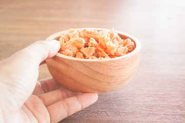 Fried shrimp chins snack in wooden bowl