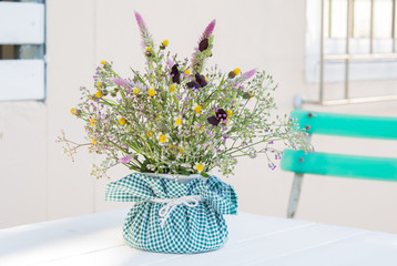 Bouque in vase on white wood table