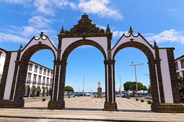 Fototapeta na wymiar Portas da Cidade gates in Ponta Delgada, the capital of Azores, Portugal. Town square with the historical entrance overlooking the ocean.