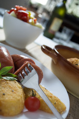 Fried sausages and breaded potatoes