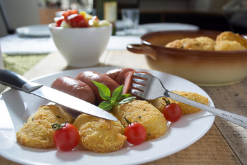 Fried sausages and breaded potatoes
