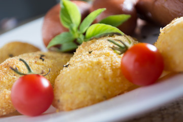 Fried sausages and breaded potatoes