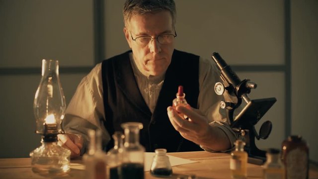 turn of the century scientist or pharmacist looking at a chemical and taking notes