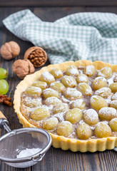 Homemade shortbread dough grape tart with walnut praline, vertical