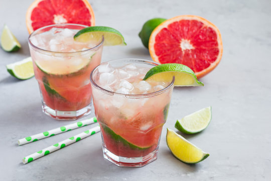 Cold pink cocktail with fresh grapefruit, lime, copy space