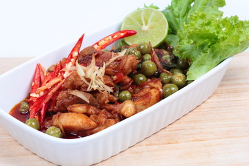 Spicy fried chicken in roasted chili sauce on selective focus.