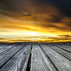 Fototapeta na wymiar Rostrum made of wooden planks on sunset