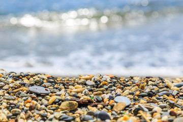 Seashore with blur waves and pebble beach