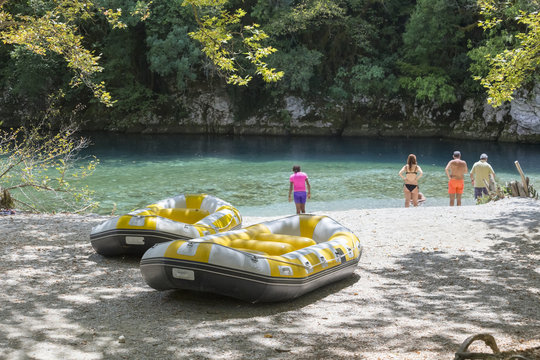 rafting boats and people swimming in Voidomatis river, Ioannina perfecture, Greece