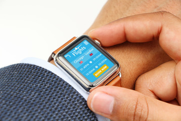 Businessman buying airplane ticket through a smart watch app
