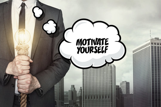 Motivate yourself text on speech bubble with businessman