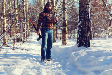 Naklejka premium sun day man with axe in the forest