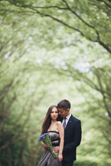 Fototapeta premium Handsome young couple posing outdoors after ceremony
