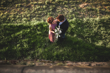 Beautiful wedding couple, girl, man kissing and photographed from above