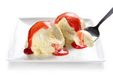 Vanilla ice cream scoops with strawberry topping