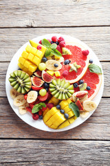 Fototapeta na wymiar Fresh fruit salad on a grey wooden table