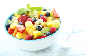 Fresh fruit salad on a white wooden table
