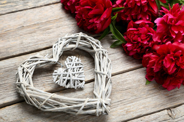 Bouquet of red peony flowers on a grey wooden table