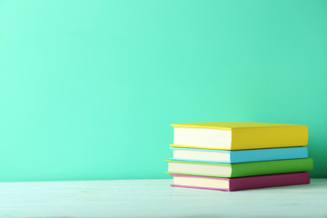 Books on a green wooden table