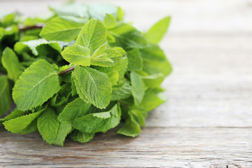 Fresh mint leafs on grey wooden table