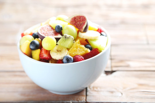 Fresh fruit salad on a brown wooden table