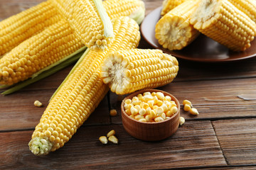 Sweet corns on a brown wooden table
