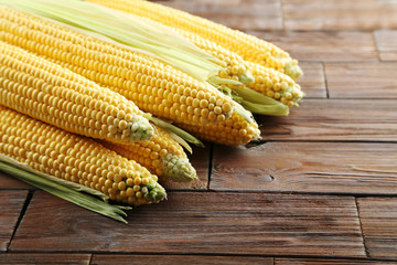 Sweet corns on a brown wooden table