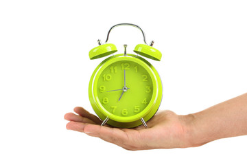 Male hand holding green alarm clock on white background
