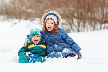 Happy children playing in the winter park.