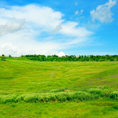 hills, green grass and blue cloudy sky