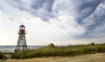 Fototapeta na wymiar Old lighthouse by the sea