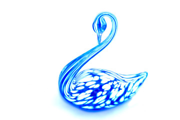 Glass swan figurine on white background