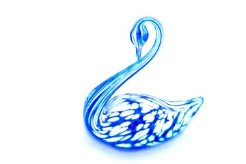 Glass swan figurine on white background