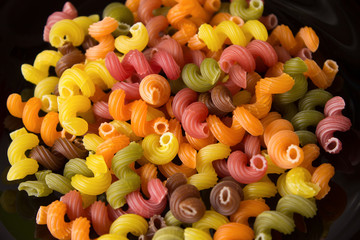 colored pasta on a dark background