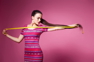 very long hair, girl measures the their hair, beautiful girl in